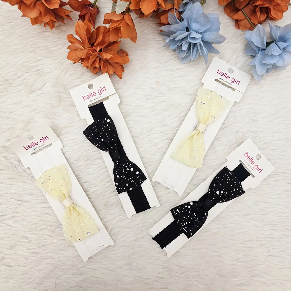 Black Cream Bow With A Speckled Or Glittery Pattern, Attached To An Elastic Headband