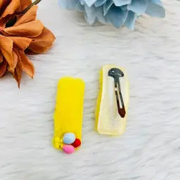 A Set Of Two Colorful Pom Pom Snap Hair Clips 6